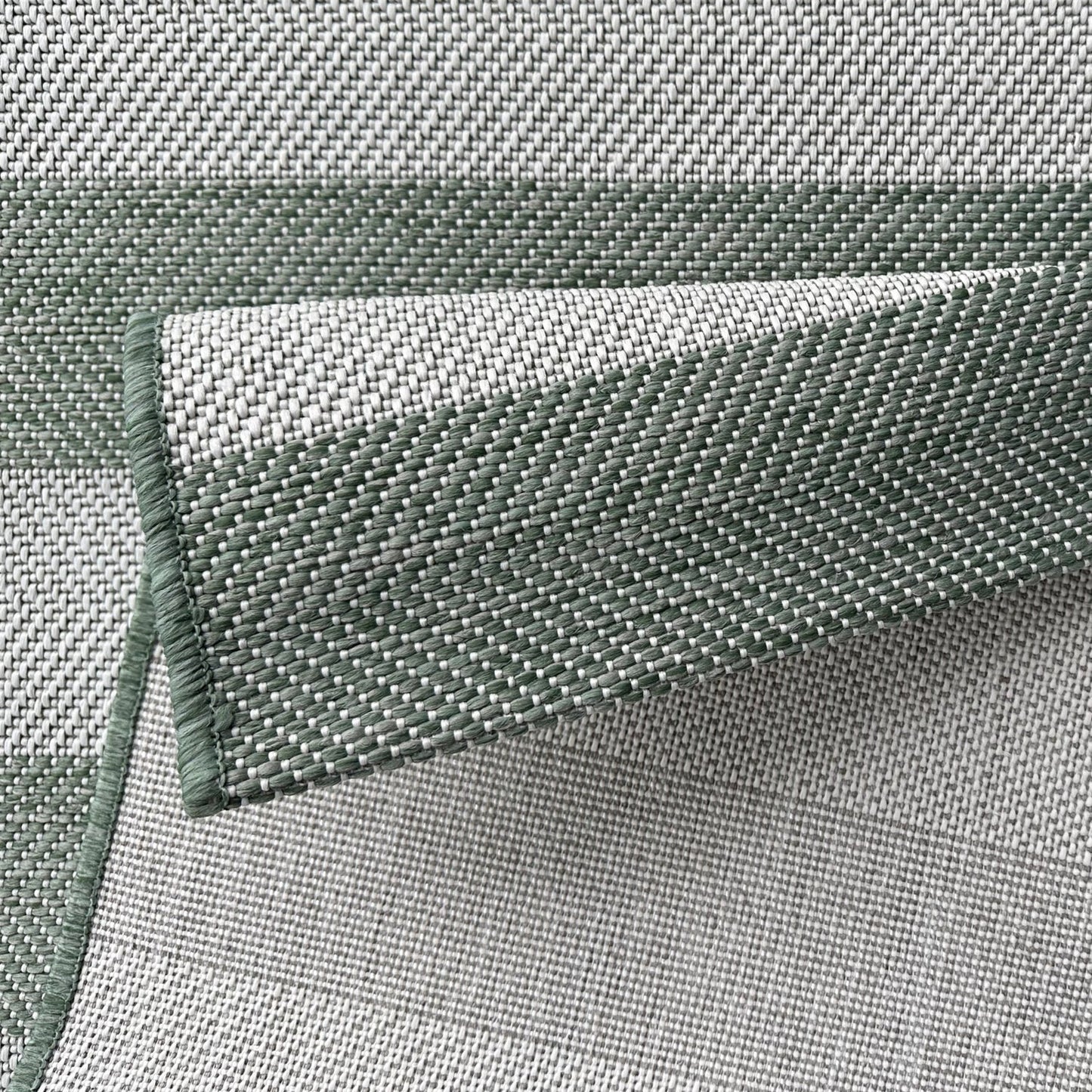 Close-up of green woven fabric with a textured pattern