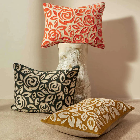 3 embroidered Aimee cushions in orange, ochre and black