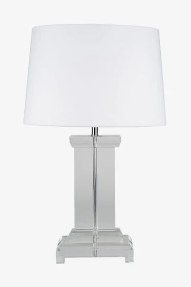 Table lamp with a white shade and clear base on a white background