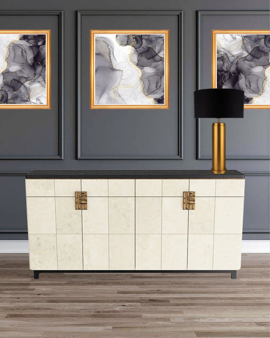 Archie Table Lamp with gold column on white dresser and gold framed artwork on wainscoting wall