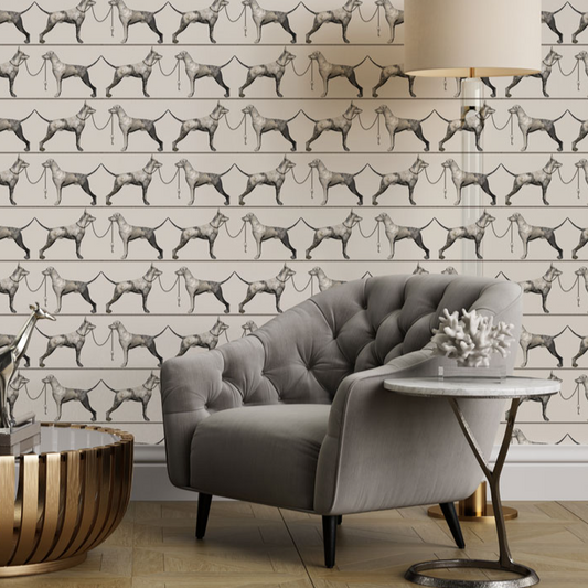 Gray armchair in a room with patterned wallpaper featuring dog illustrations.