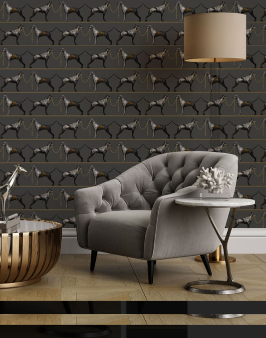 Living room with gray sofa, decorative table, and patterned wall featuring dog illustrations.