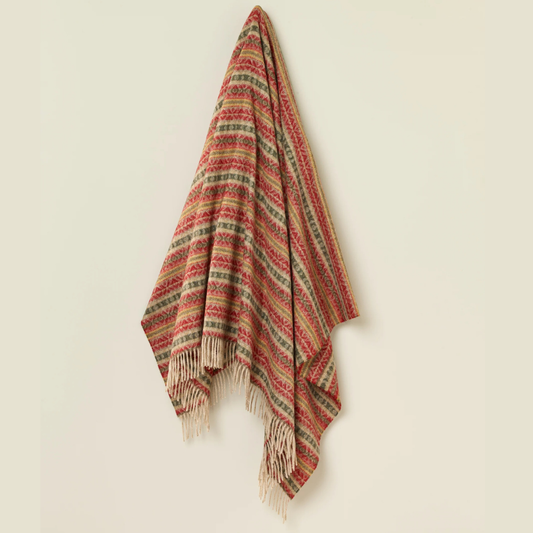 Woven blanket with red and green pattern on a beige background