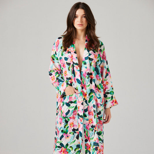 Woman wearing a floral pajama set on a plain background