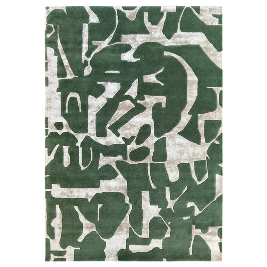 Green and beige abstract patterned rug on a white background
