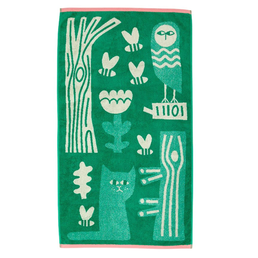 Green towel with white animal and nature-themed designs on a white background