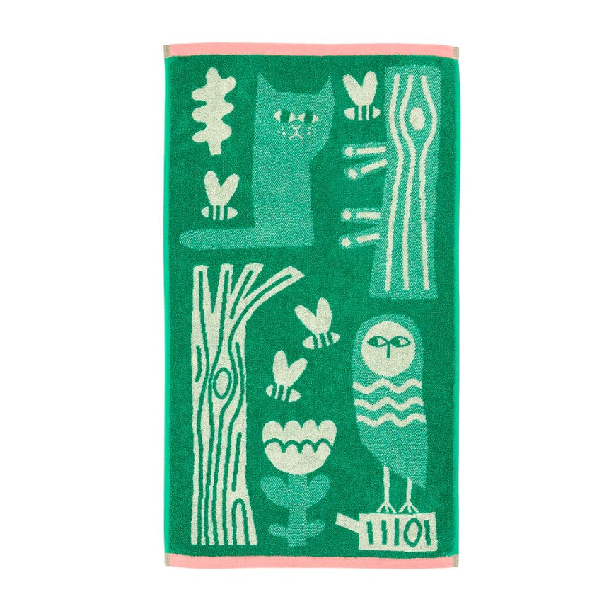 Green towel with animal and nature patterns on a white background
