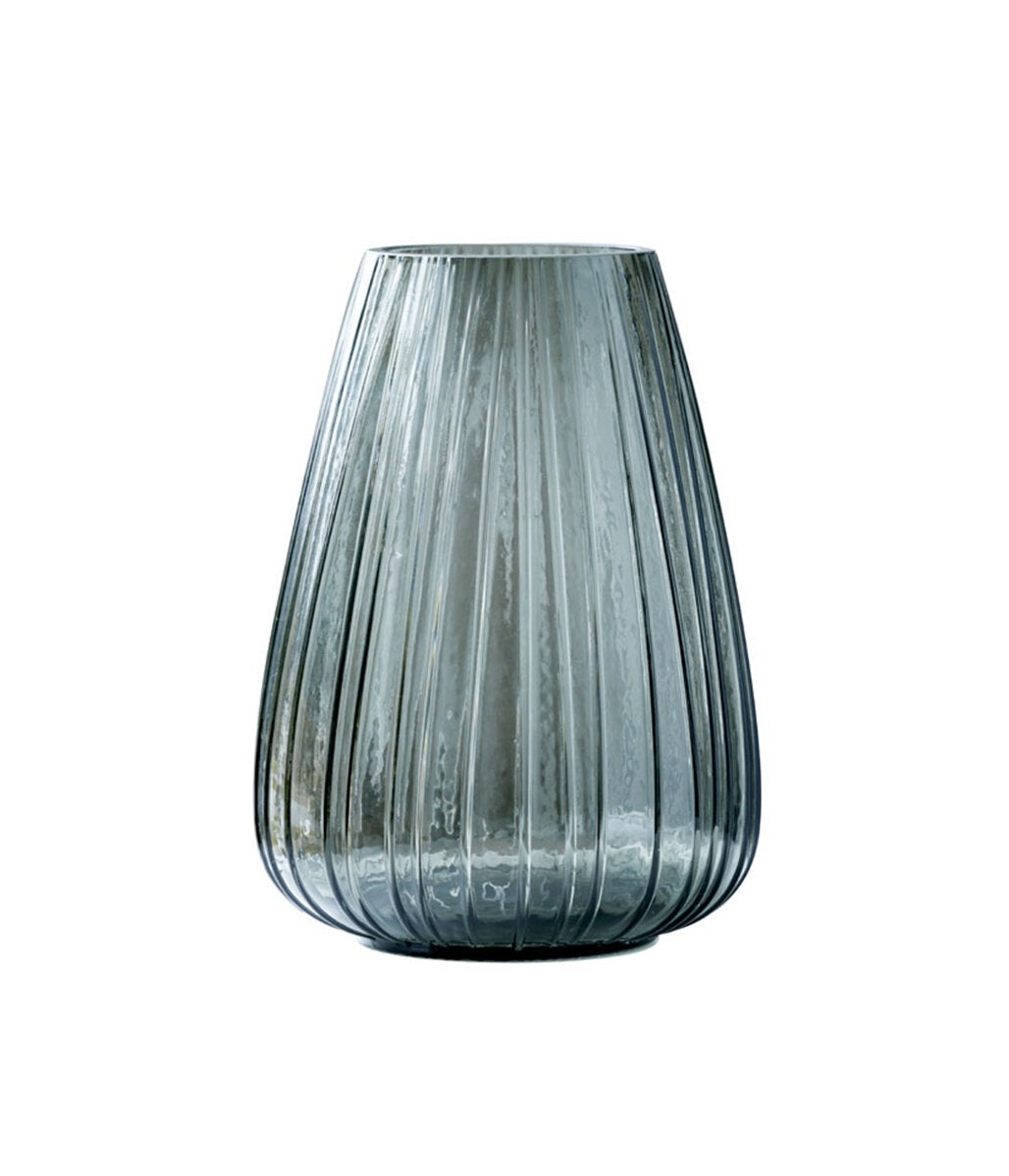 Tall, ribbed glass vase on a white background