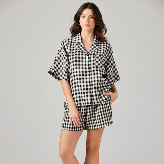 model wearing black and white checked linen pyjama top and shorts
