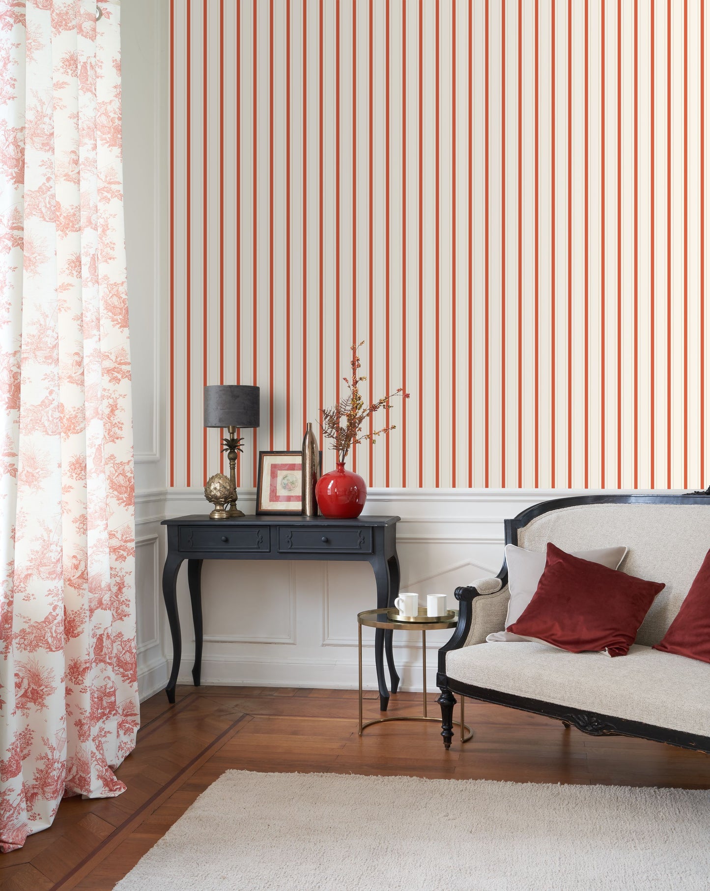 Living room with striped wallpaper, floral curtains, and decorative furniture.
