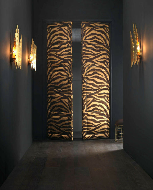 Zebra print room dividers in a dark room with wall lights.