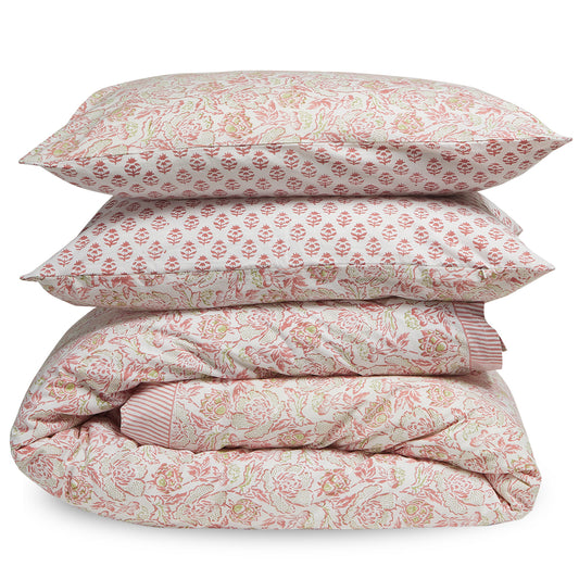 Floral patterned bedding set with a comforter and two pillows on a white background