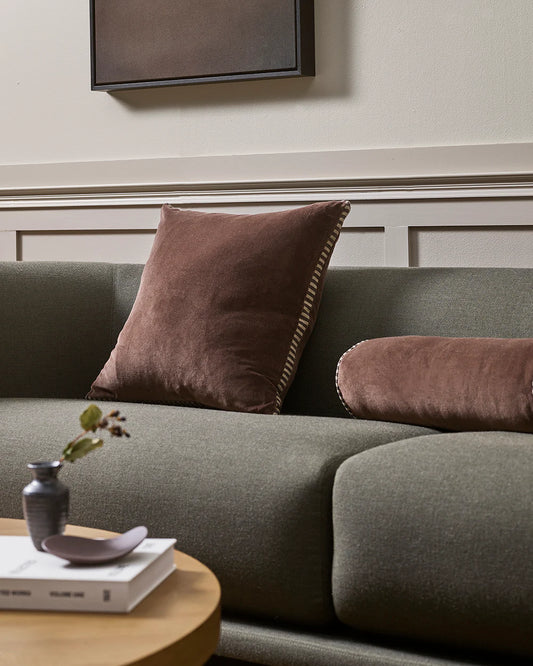Gray sofa with brown cushions in a living room setting