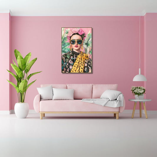Living room with pink walls, a pink sofa, and a colorful painting of Frida Kahlo with flowers on the wall.
