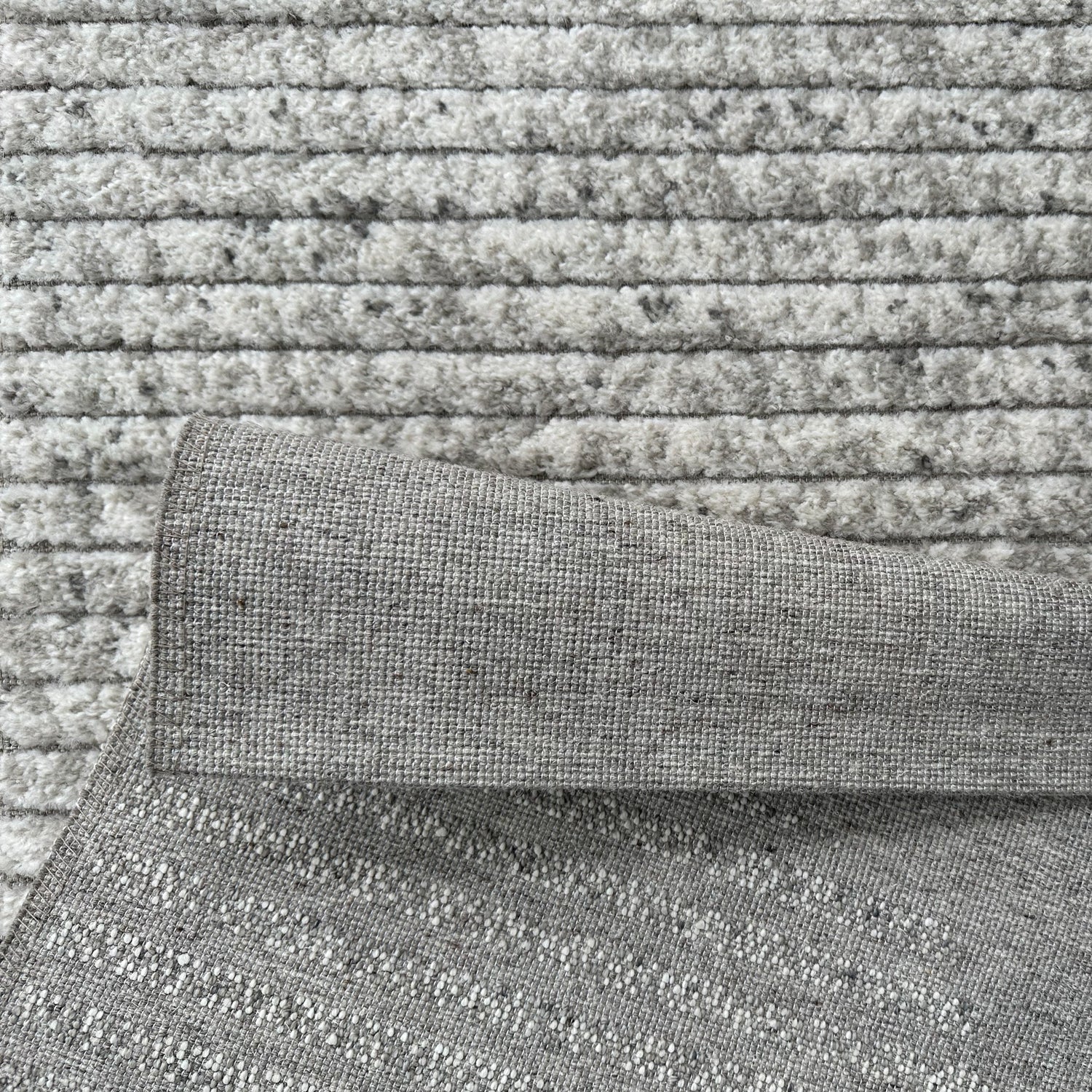 Close-up of textured gray fabric with a patterned surface