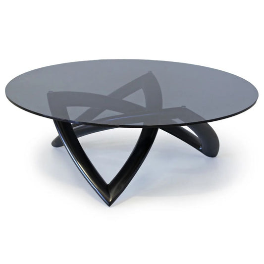 Modern glass coffee table with black base on a white background
