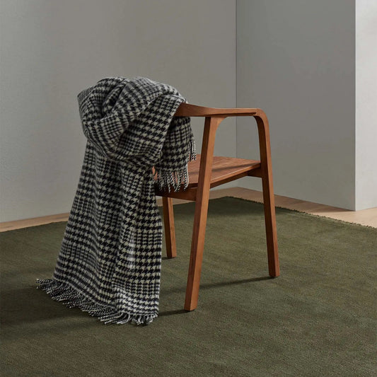 black and white houndstooth check throw over a wooden chair