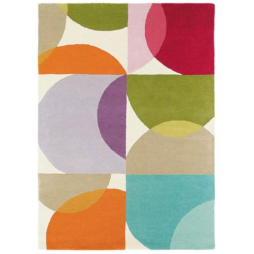 A rectangular area rug with a mid-century modern geometric pattern of overlapping semi-circles in orange, green, pink, purple, beige, and turquoise on an off-white background.