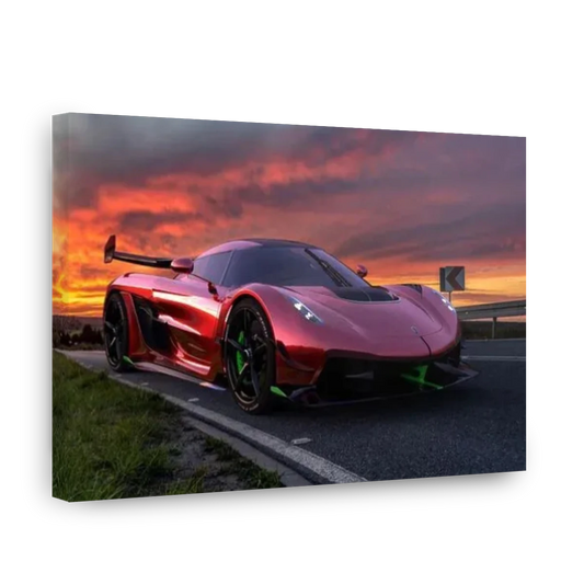 A rectangular wall art print or canvas showing a glossy red supercar on a road at sunset, photographed against a plain white background.