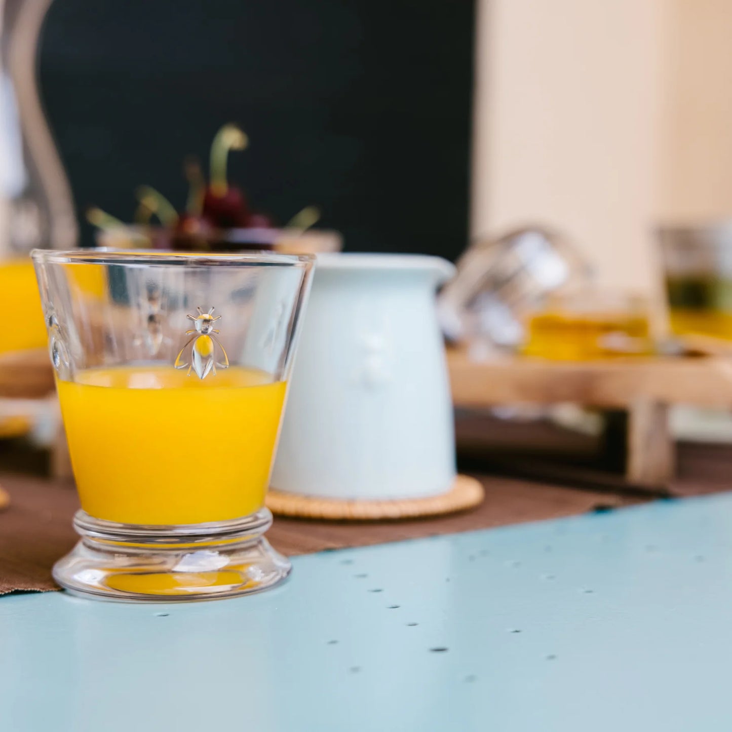 Glass of orange juice on a table with a blurred background