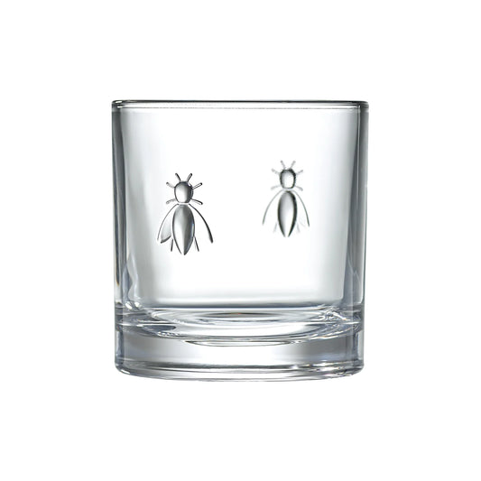 Clear glass tumbler with bee designs on a white background
