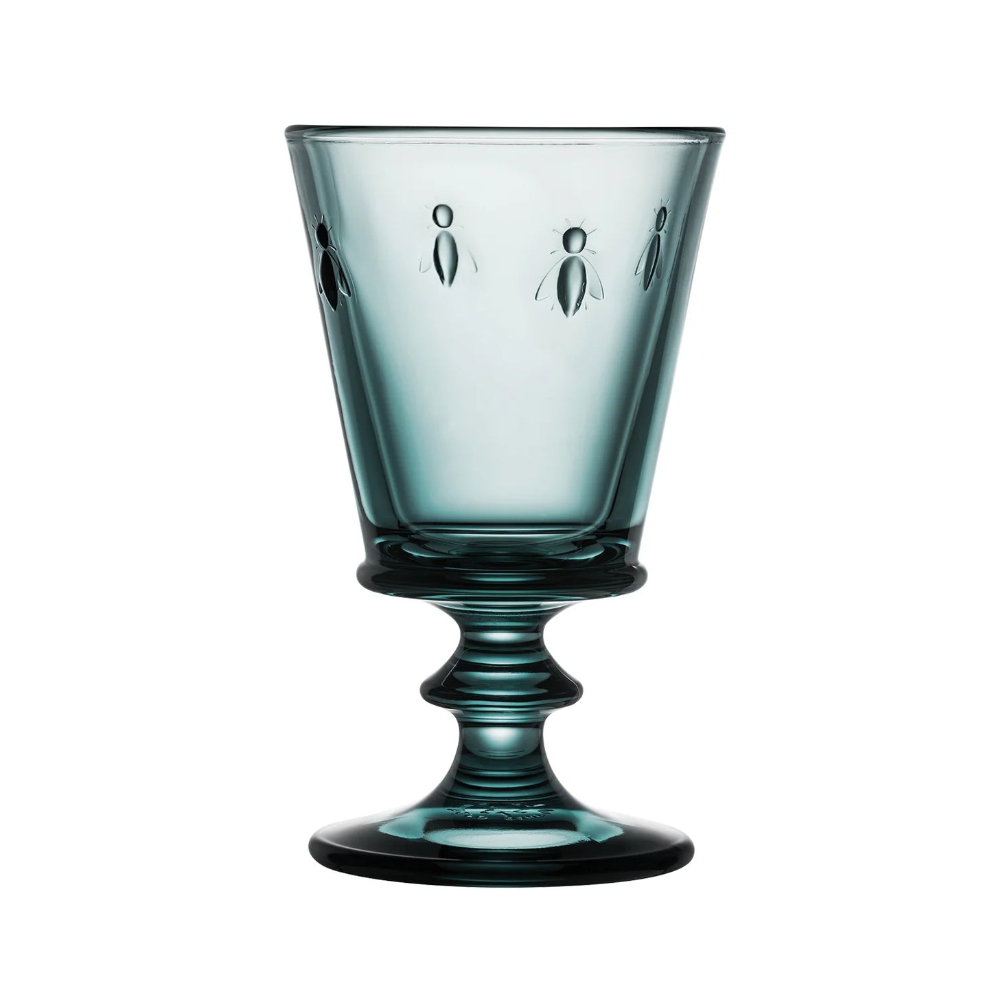 Blue glass goblet with engraved designs on a white background