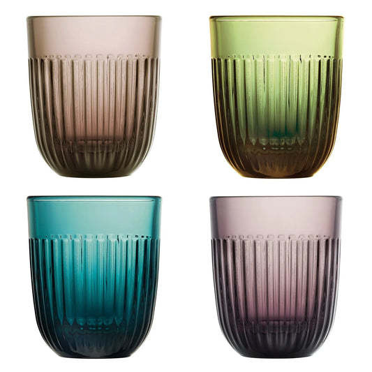 Four glass tumblers in different colors on a white background