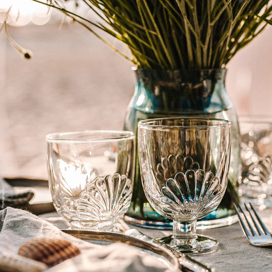 Two decorative glass goblets on a table with a blurred background