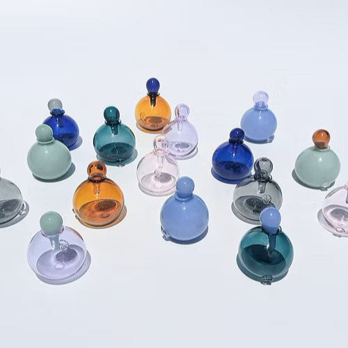 Selection of colourful lidded glass vases