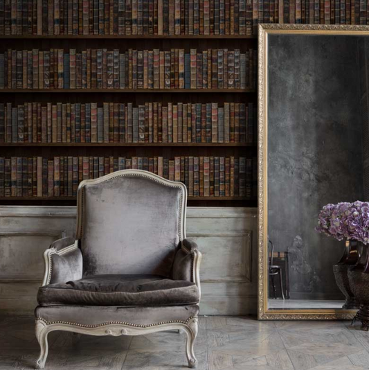 library wall paper with a large mirror and grey traditional chair