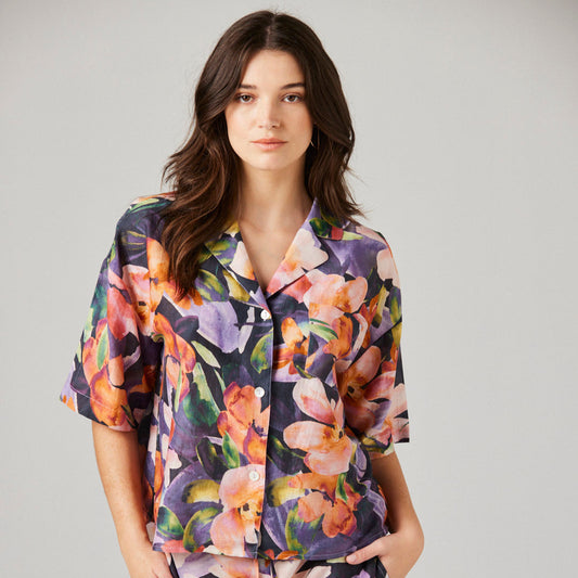 Vibrant floral button down silk pyjama top on dark haired model