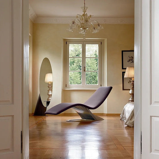 Modern interior design with a brown lounge chair, chandelier, and large window.