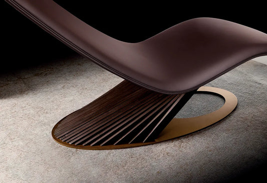 Modern brown lounge chair with a unique base design on a neutral background
