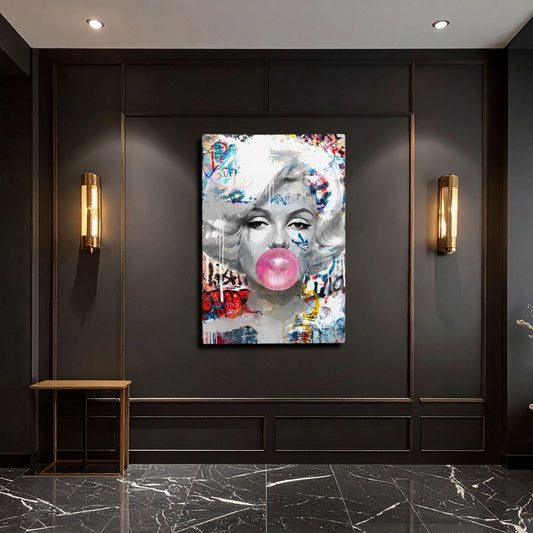 art work featuring marilyn monroe blowing bubble gum in graffiti style art, hanging on a black wall with gold outlined panels and long art deco style lights either side, black and white marbled floor