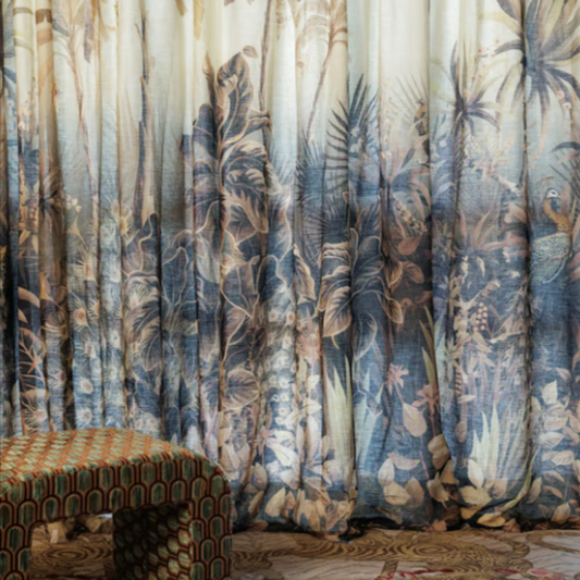 Decorative curtain with palm tree pattern in a room with a patterned chair and rug.
