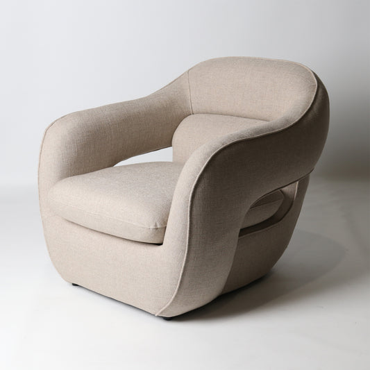 Architectural rounded open sided lounge chair in neutral fabric