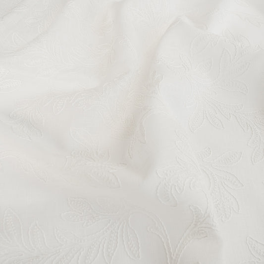 white embroidered drapery fabric wthi leaf pattern