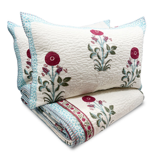 Floral quilt with embroidered designs on a white background