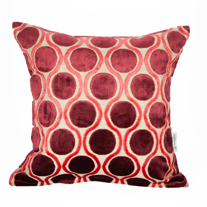 Decorative pillow with red and beige circular pattern on a white background