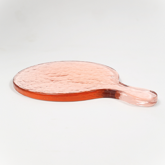 pink glass serving board on a light gray background