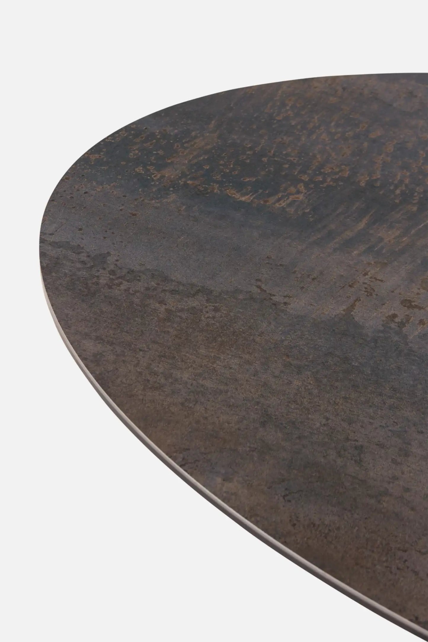 Round metal table top with a textured surface on a white background