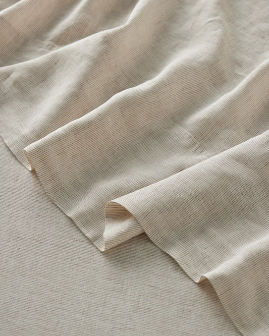 Close-up of Sova bed linen with a subtle texture on a matching background