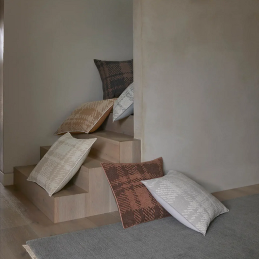 Sienne cushions with a large check, piled on the stairs