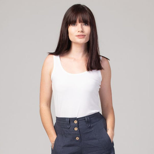 white silk tank top and jeans on model with brown hair