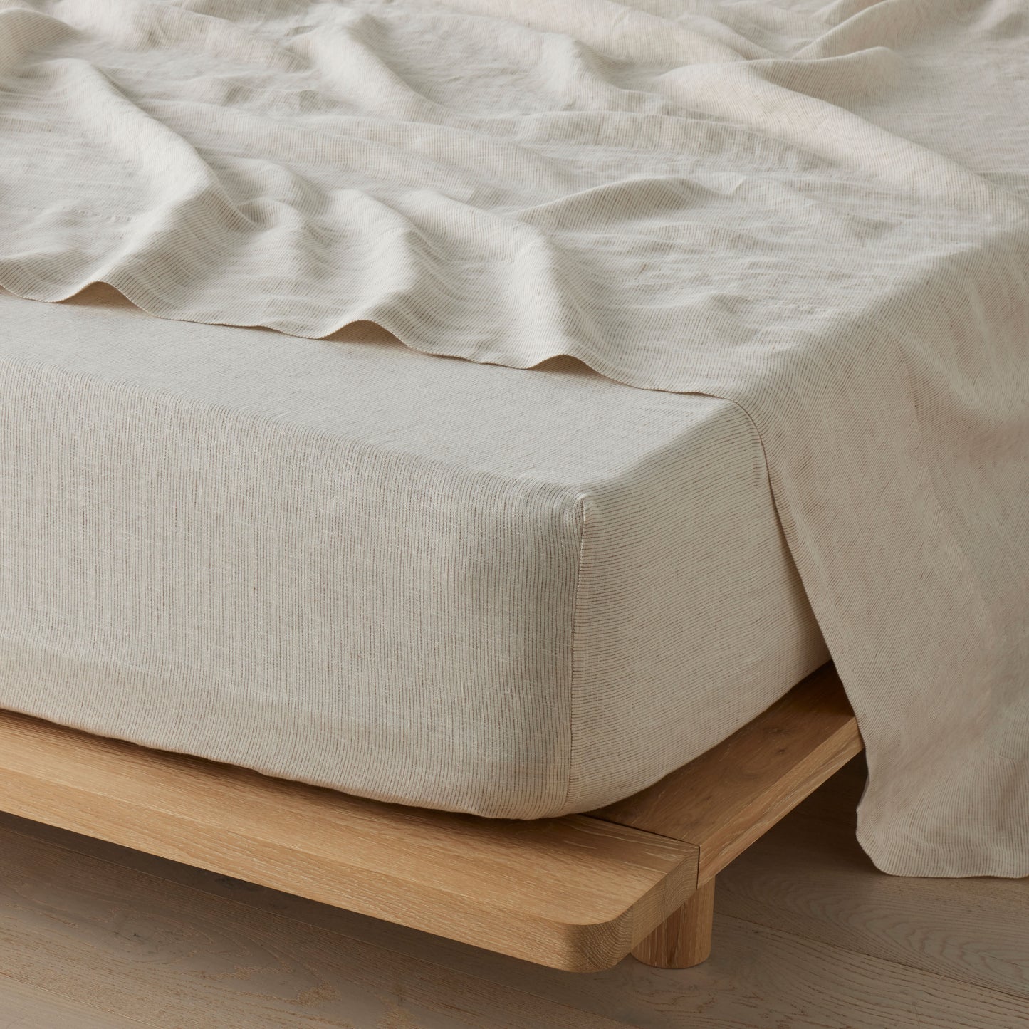 Beige bedding on a wooden bed frame