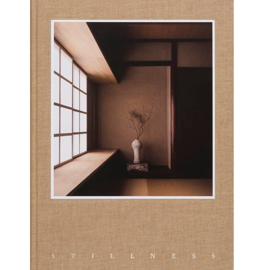 Book cover with a minimalist interior scene and the word 'STILLNESS'.
