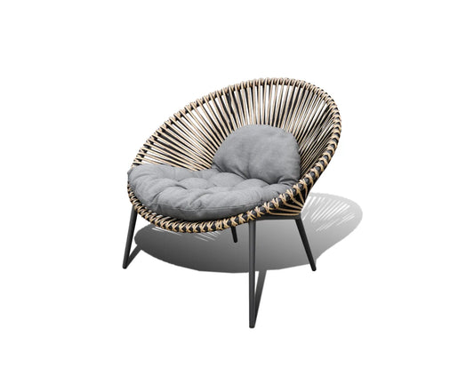 Round wicker chair with a grey cushion on it