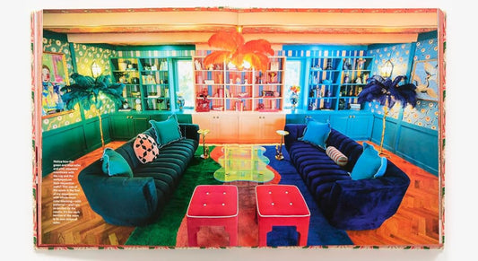 Colorful interior design book with images of living rooms.