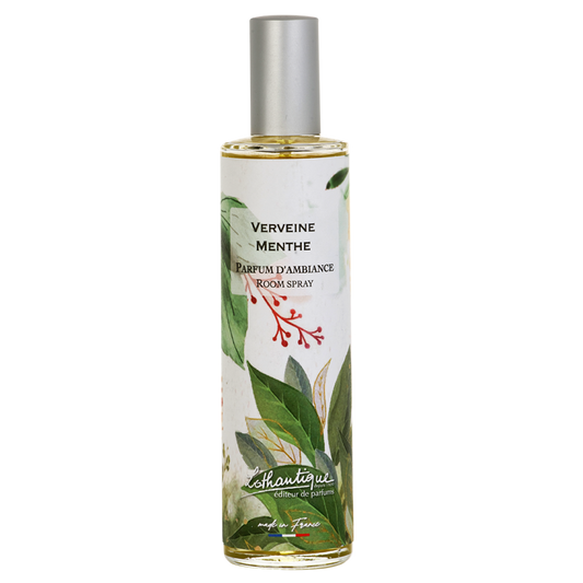 Room spray bottle with green leaf design and white label on a white background