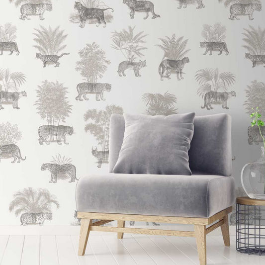 Gray velvet sofa with a patterned wall featuring animals and plants.